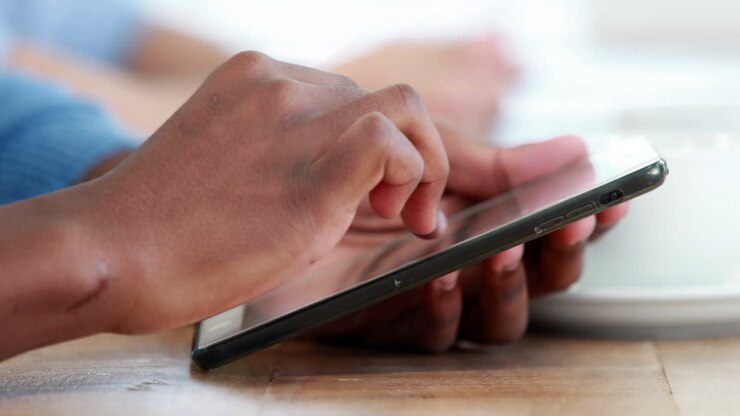 Close up view of businessman using tablet computer