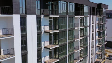 newly built urban architecture. exterior of residential building in the city. modern building with tall glass windows and balconies.
