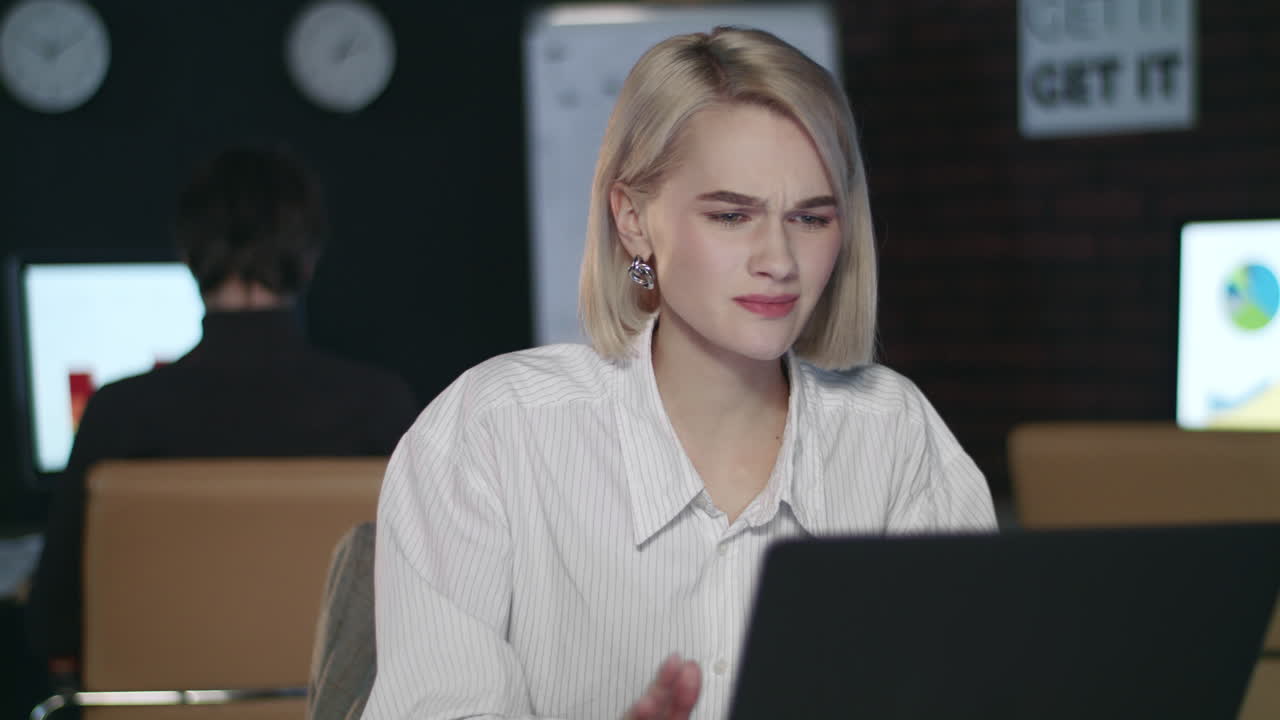 Frustrated business woman working in late office. Upset woman in night offic