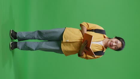 student with book and backpack