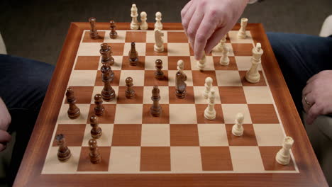 Chess-Game-Moves,-Two-Men-Moving-And-Taking-Pieces-With-View-Of-Whole-Board,-Slow-Motion