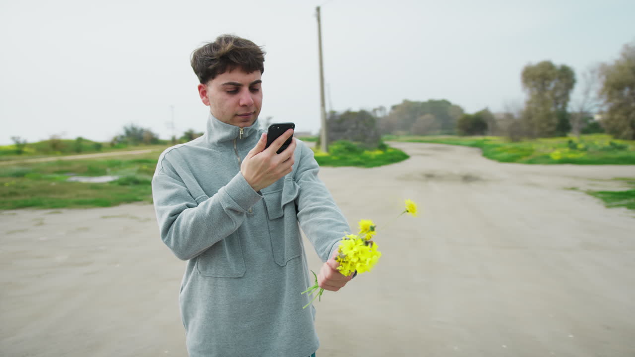 Man Doing A Picture To The Flowers He Picked For His Mom