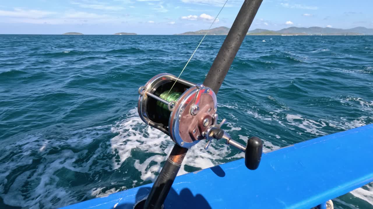 A fishing reel on a boat in Phuket, Thailand, captures the essence of a serene ocean adventure