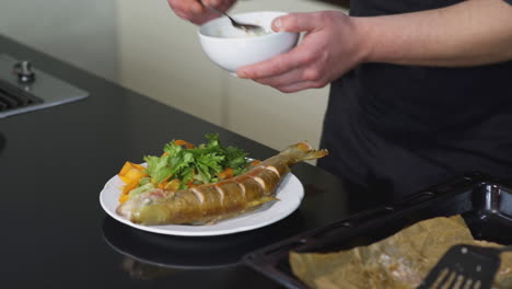 preparing roasted fish with sauce