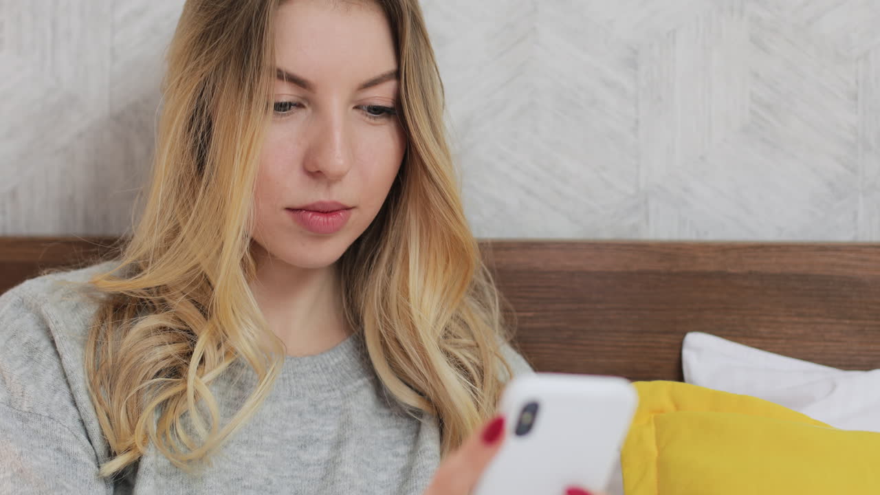 Woman using a smartphone in bed