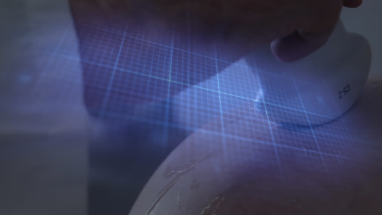 Heartbeat monitor over hand of diverse female doctor and pregnant patient having ultrasound scan