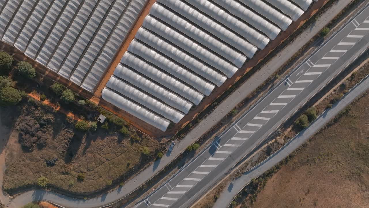 Overhead Shot Of Strawberry Plantation Tents Near Main Road