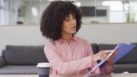 African-american-businesswoman-having-video-call-at-office,-slow-motion