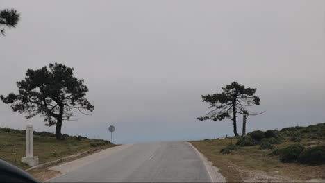 driving over mountain pass with misty view in slow motion