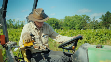 el granjero con sombrero trabaja en un pequeño tractor