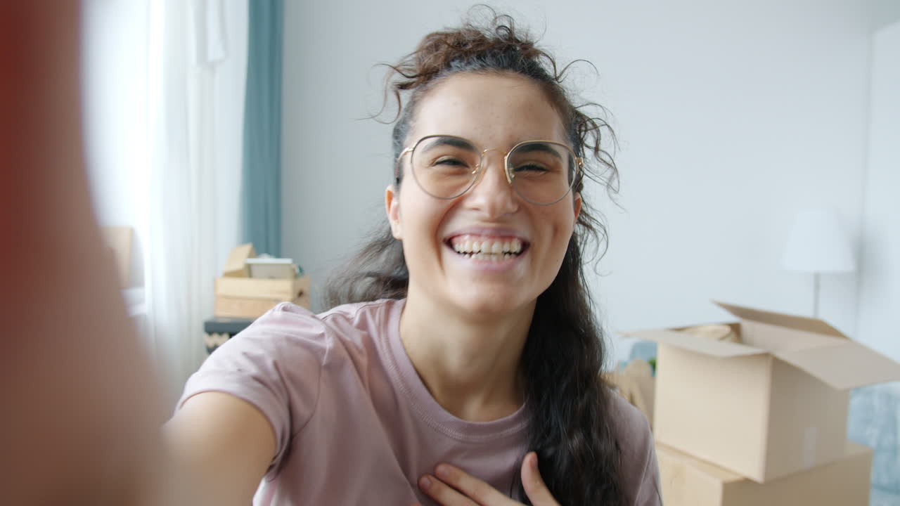 Happy woman taking selfie while moving