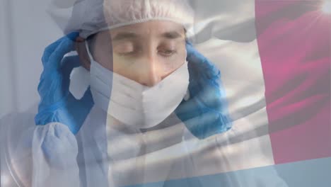 french flag waving against female scientist wearing protective clothes