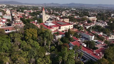 cuernavaca with lush greenery, colonial architecture, and a church tower , aerial view