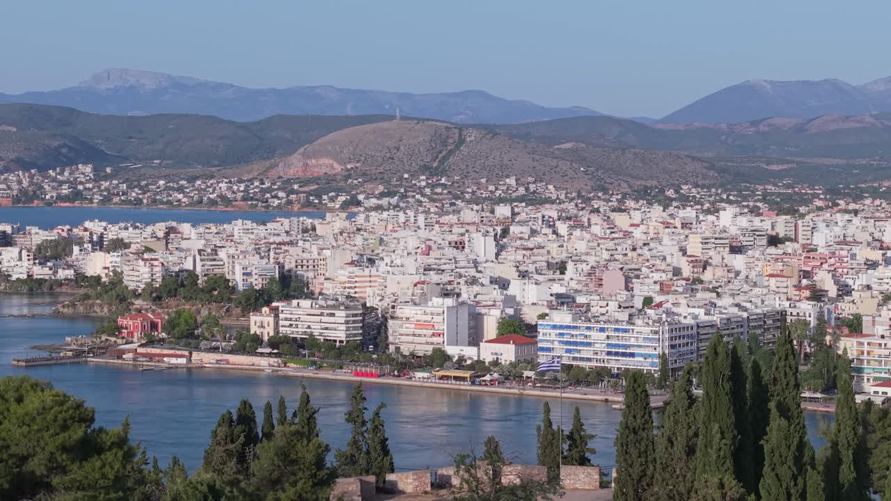 A panoramic drone view of Chalkida’s seaside, capturing the city’s coastal charm, waterfront walkway, and vibrant urban-meets-nature atmosphere.