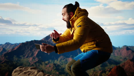 foolish hiker acting careless dropping smartphone and losing balance
