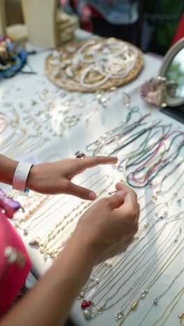 woman shopping for jewelry at a market