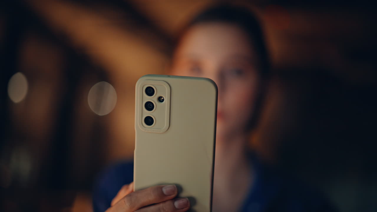 Joyful businesswoman reading mobile phone message at night apartment closeup