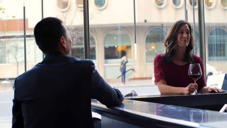 Business-people-interacting-with-each-other-at-bar-counter-in-hotel-4k