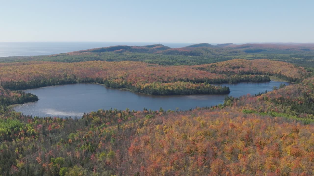 Aerial View of Lake Agnes Surrounded by Vibrant Fall Forest in Lutsen Minnesota