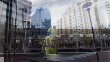 construction worker staring at buildings