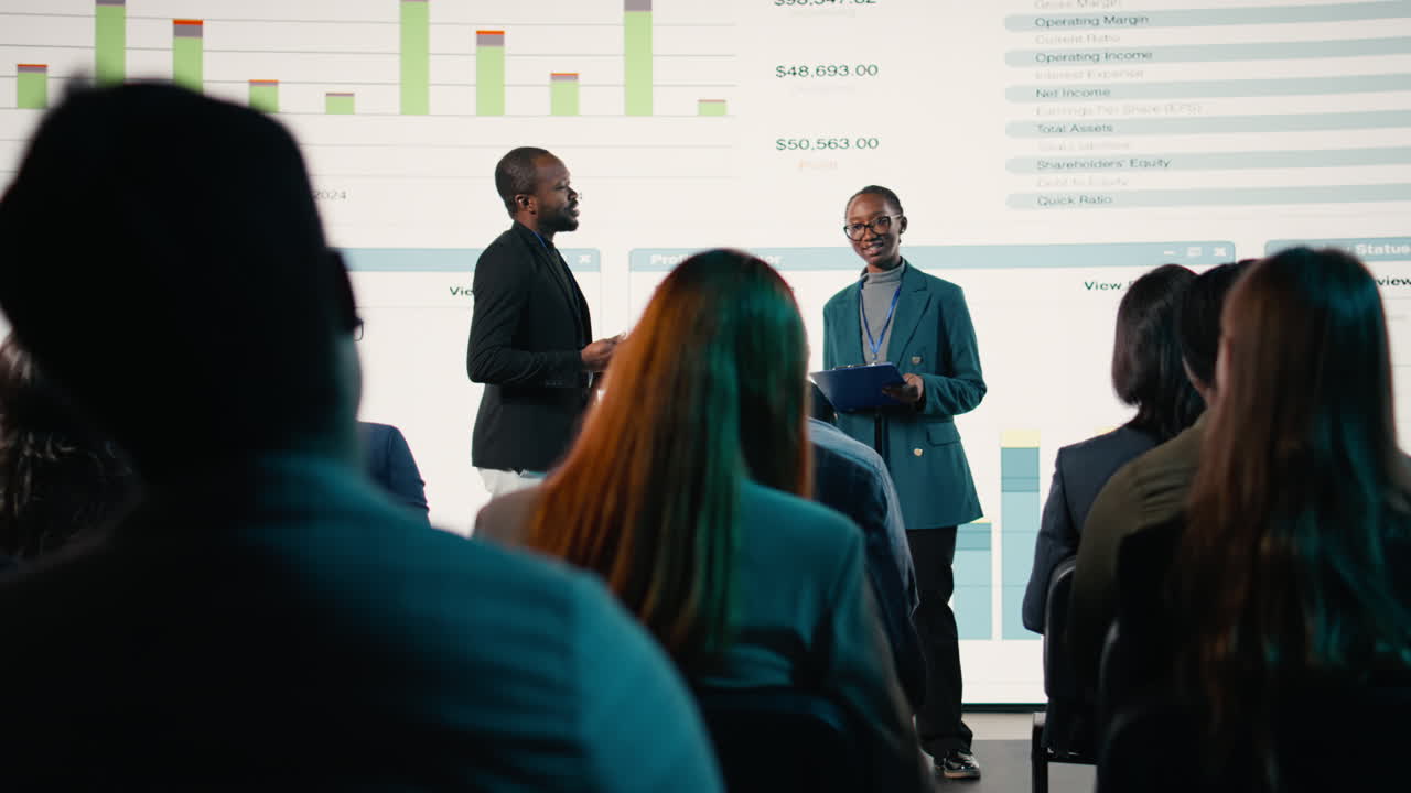 Black male and female hosting a presentation at the business conference event