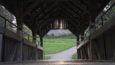 Wooden-Footbridge-with-Sunlight-Beaming-Through-the-Wooden-Rooftop-at-Whitby,-Canada