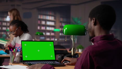 vertical video college student looks at a copy space on laptop while collecting notes