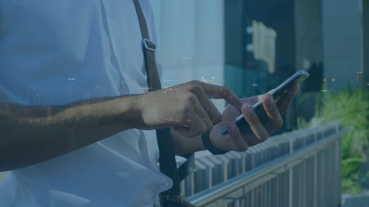 Animation of man using smartphone over cityscape