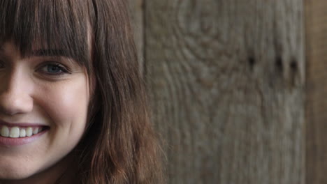 portrait of cute young woman smiling looking at camera blue eyes caucasian female beauty on wooden background