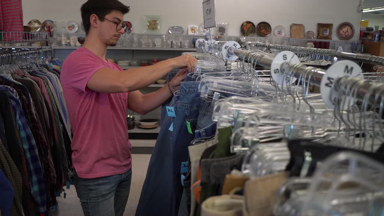 Man shopping for clothes at a thrift store