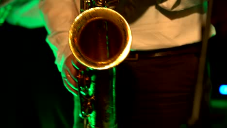 saxophonist play on golden saxophone. live performance