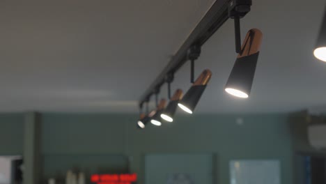 slow orbiting shot of a polished silver light hanging in the kitchen