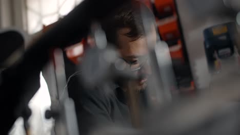 man concentrated on repair work in a workshop
