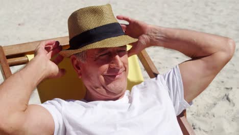 senior man relaxing on beach chair at beach