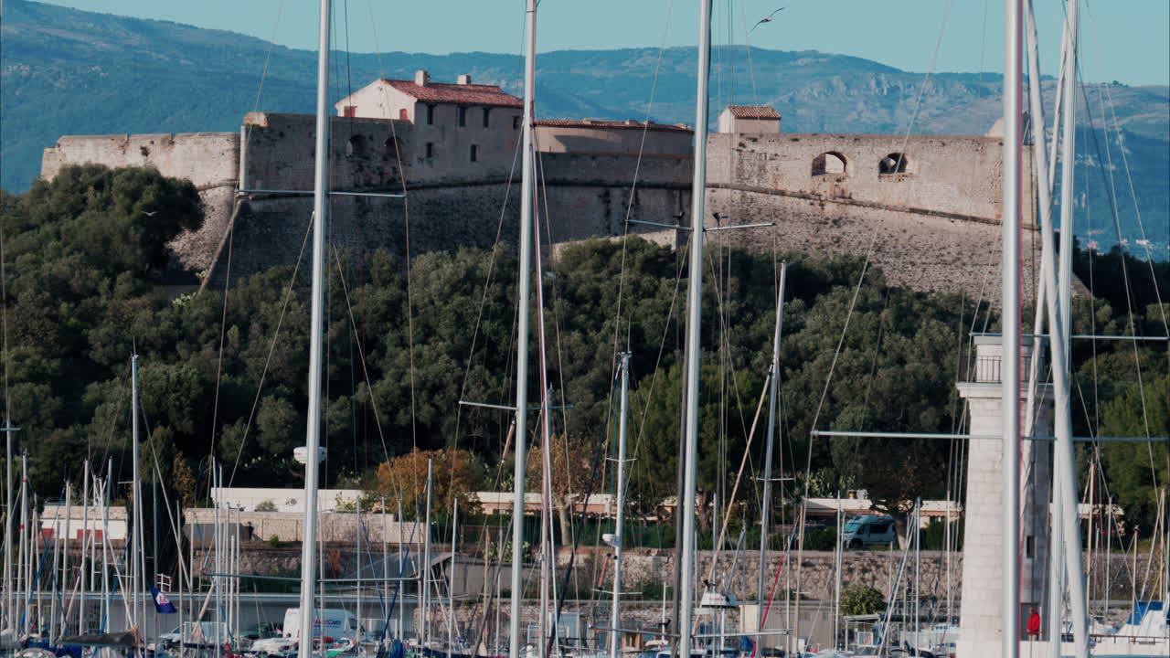 Boats docked in the Port Vauban with he Fort Carre on the background in Antibes, France