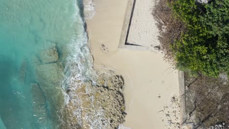 waves rolling onto a sandy beach on grand turk island in the turks and caicos archipelago