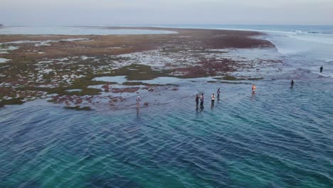 indonesian fishermen on uluwatu, bali ocean coast - aerial drone view