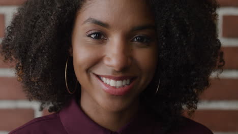 portrait happy african american woman smiling with brick wall background