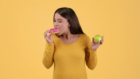 woman choosing between a donut and an apple