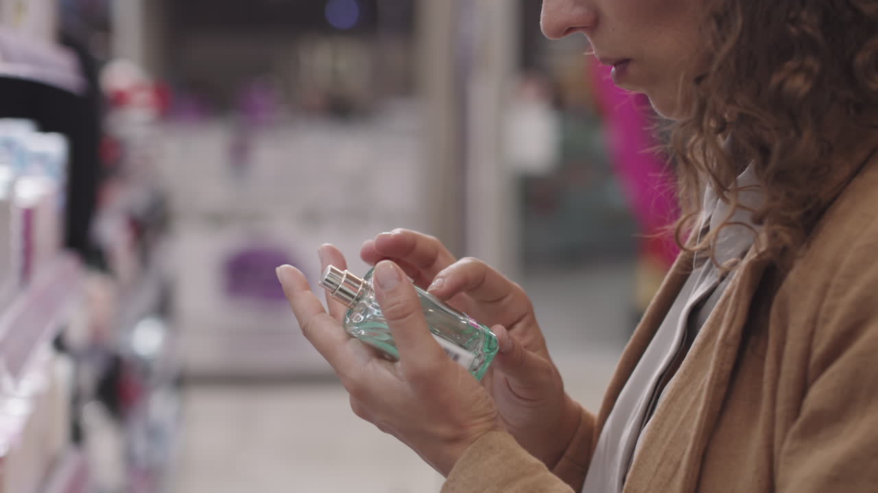 Woman Examining Perfume Bottle In Beauty Shop