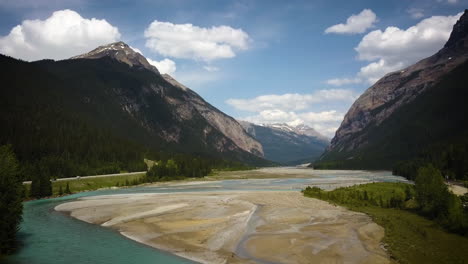 Cinematic-drone-shot-over-a-bridge-in-a-large-mountain-range