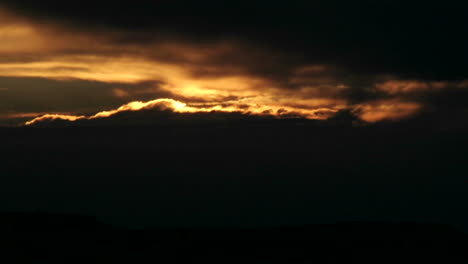 The-bright-sun-disappears-behind-clouds-in-a-darkening-sky