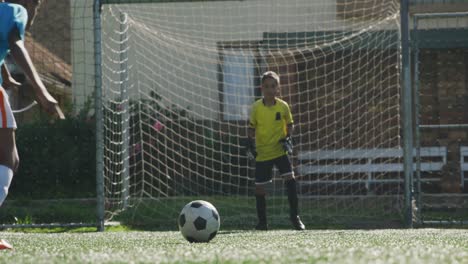 Afroamerikanisches-Fußballkind-In-Blau,-Das-An-Einem-Sonnigen-Tag-Punktet