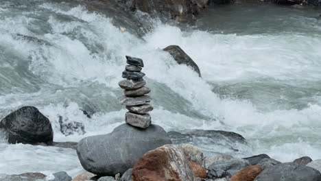 balanced stones in a mountain stream
