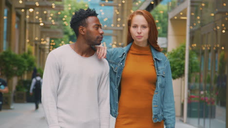 portrait of young couple of vloggers or social influencers travelling through city for social media