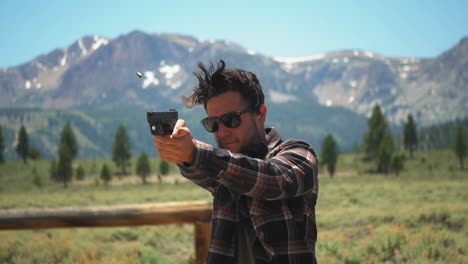 White-man-aims-and-fires-a-Glock-9mm-pistol-in-stunning-Mammoth-Lakes