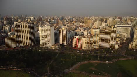 aerial - costa verde zone in miraflores, lima, peru, wide shot rising tilt down