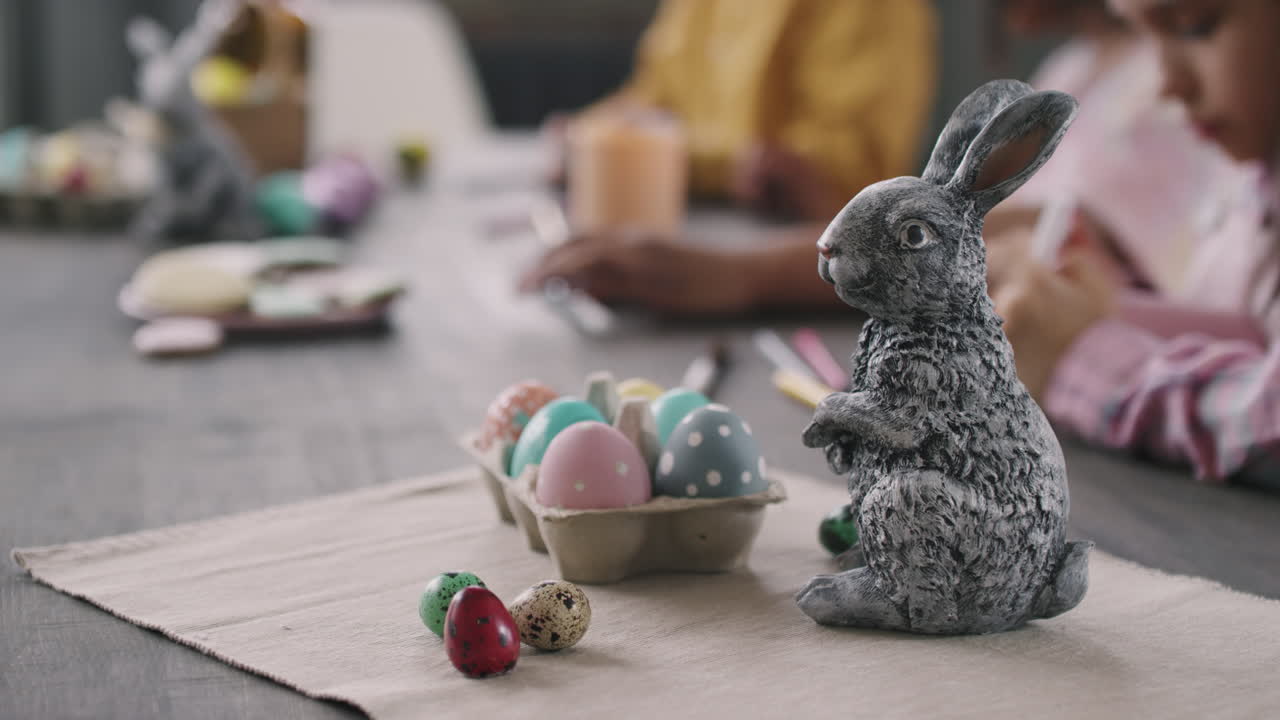 Close Up of Easter Bunny Figurine and Eggs