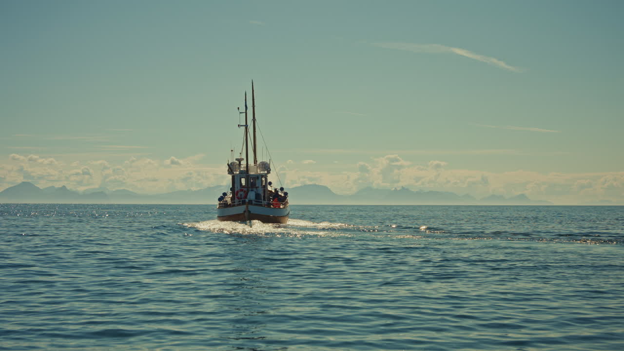 Close up shot of a small fishing boat navigating on the Norwegian sea, close to the Lofoten Islands, Norway