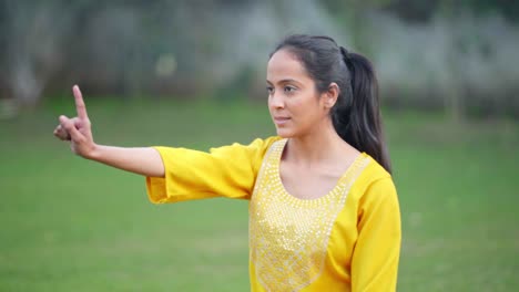 female yoga teacher teaching online class